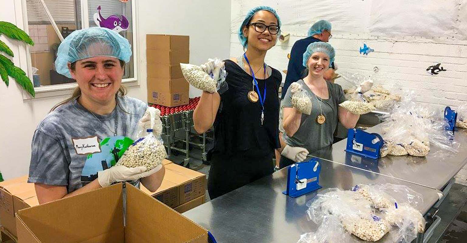Kids packing lunches for elderly